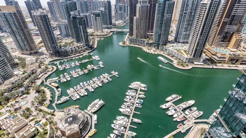 Aerial view of Dubai Marina with yachts and high-rise residential towers